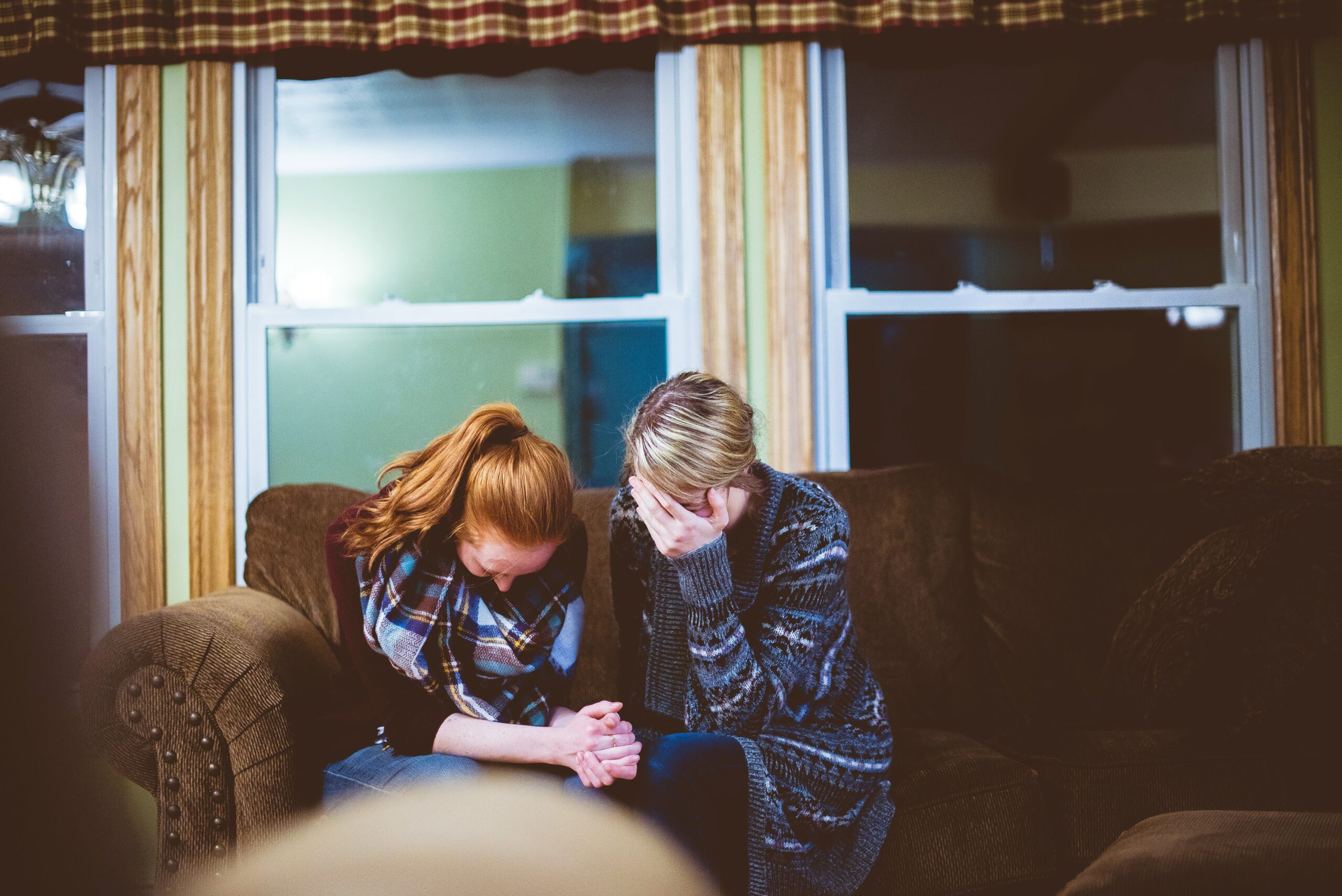 Mother and daughter experiencing emotional distress, both with their hands over their faces, symbolizing the struggle to connect in parenting.